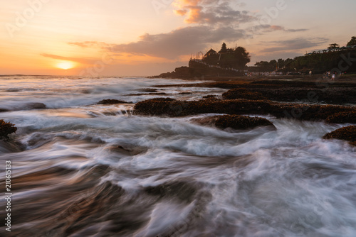 Seascape in sunset with strong wave at Tanah Lot Temple in Bali  Indonesia. Famous landmark tourist attraction and travel destination 