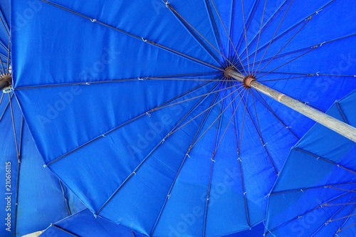 Looking up at a blue parasol, big umbrellas at the Cha am beach, Thailand