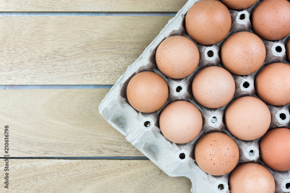 Top view egg tray on the old wooden table floor background Top view egg tray on the old wooden table floor background