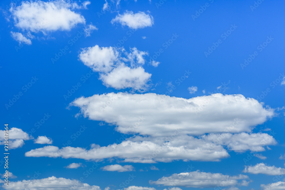 White fluffy clouds in a deep blue sky White fluffy clouds in a deep blue sky