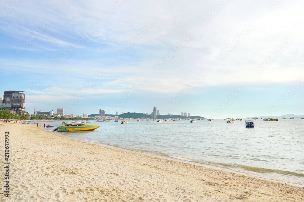 PATTAYA, THAILAND - MAY 19, 2018 : Speed boats anchored waiting for tourist at pattaya beach in the evening, People playing the sea. Many tourists visit here. View for seascape. Space for text in temp