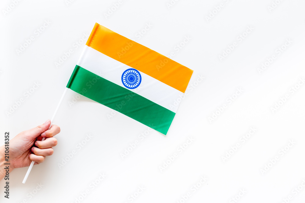 Indian flag concept. Hand hold small flag on white background top view copy  space Stock Photo | Adobe Stock