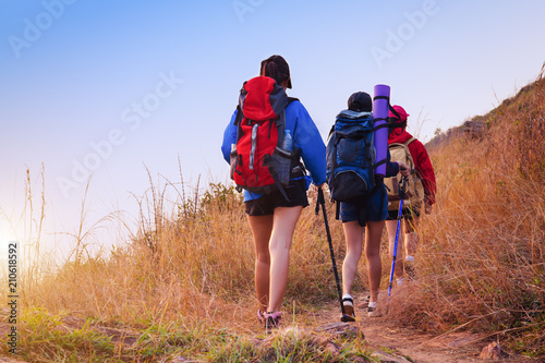 Asian people hiking with tent in the forest and camping during summer at sunset.