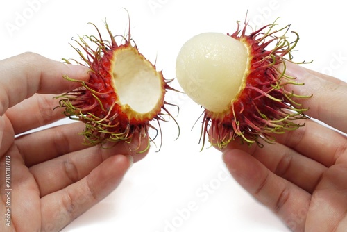 Top view of rambutan on a woman's hand isolated on white background, Tropical fruit, copy space. (Nephelium lappaceum)