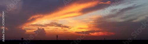 Dramatic atmosphere panorama view of beautiful tropical twilight sky and clouds in silhouette summer rural landscape.