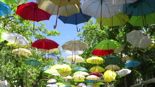 Festive Street with Colorful Umrellas as decoration and wind blowing photo