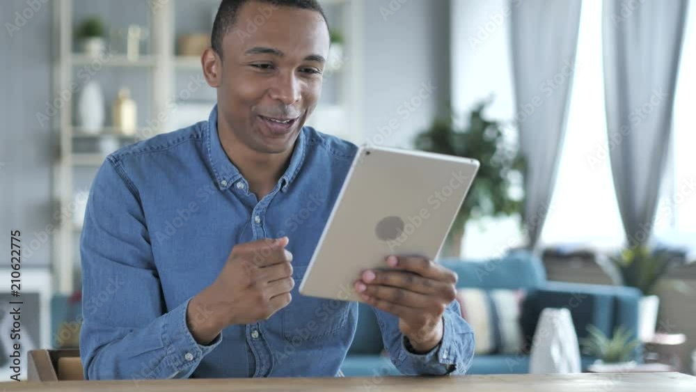 Online Video Chat by Young African Man on Tablet PC Online Video Chat by Young African Man on Tablet PC