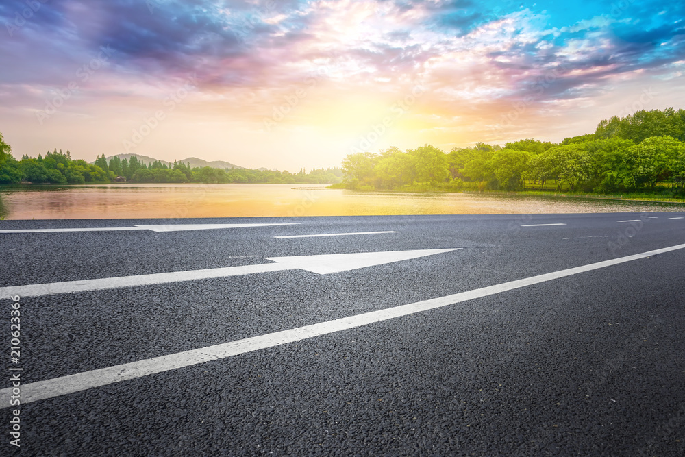 The empty asphalt road and natural landscape under the blue sky The empty asphalt road and natural landscape under the blue sky