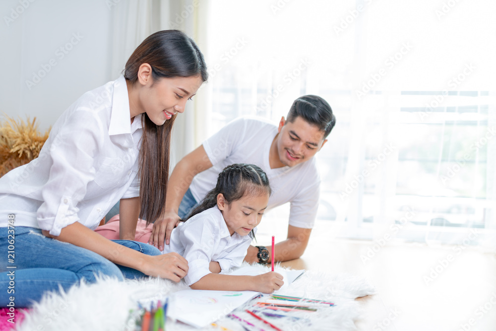 Young family drawing together with colorful pencils at home,Asian kids and happy people concept.kid girl drawing with color pencils,Hand of asian child draw and paint with crayon in vintage color tone Young family drawing together with colorful pencils at home,Asian kids and happy people concept.kid girl drawing with color pencils,Hand of asian child draw and paint with crayon in vintage color tone