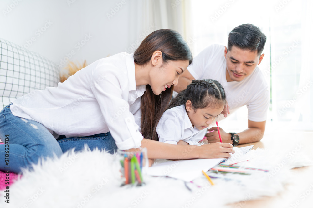 Young family drawing together with colorful pencils at home,Asian kids and happy people concept.kid girl drawing with color pencils,Hand of asian child draw and paint with crayon in vintage color tone Young family drawing together with colorful pencils at home,Asian kids and happy people concept.kid girl drawing with color pencils,Hand of asian child draw and paint with crayon in vintage color tone