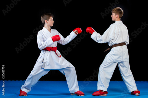 The studio shot of group of kids training karate martial arts