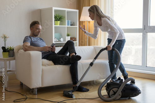 Young couple arguing about housekeeping issues photo