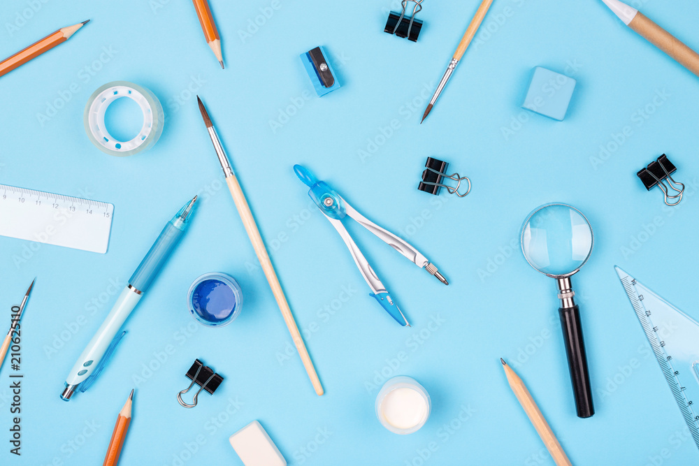 Pattern made of school stationary on blue background. Top view, flat lay. Pattern made of school stationary on blue background. Top view, flat lay.