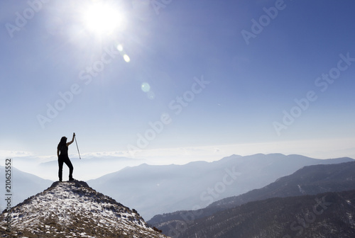 woman hiker on cliff of mountain