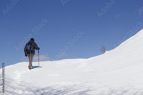 hikers walking in the snow in mountain