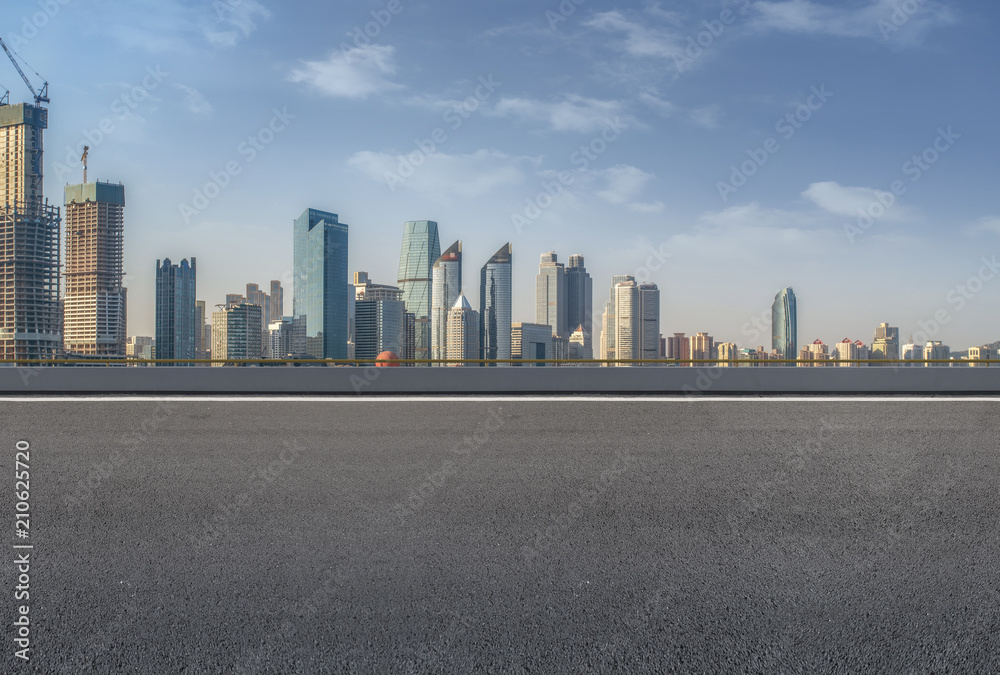 The empty asphalt road is built along modern commercial buildings in China's cities. The empty asphalt road is built along modern commercial buildings in China's cities.
