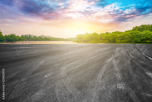 The empty asphalt road and natural landscape under the blue sky