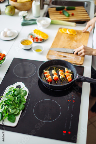 Fresh organicvegetables on white desk background on cutting board. Healthy natural food on rustic wood. Tomato, lettuce, carrot, pepper, zucchini and other cooking ingredients top view photo