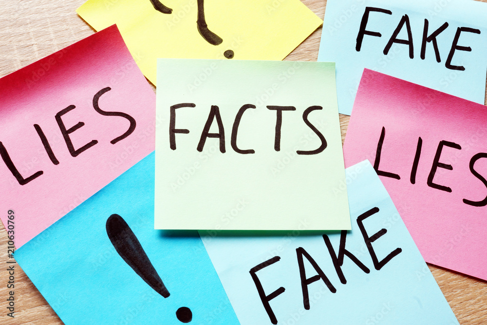 Memo sticks with words Facts, lies and fakes. Modern news concept.