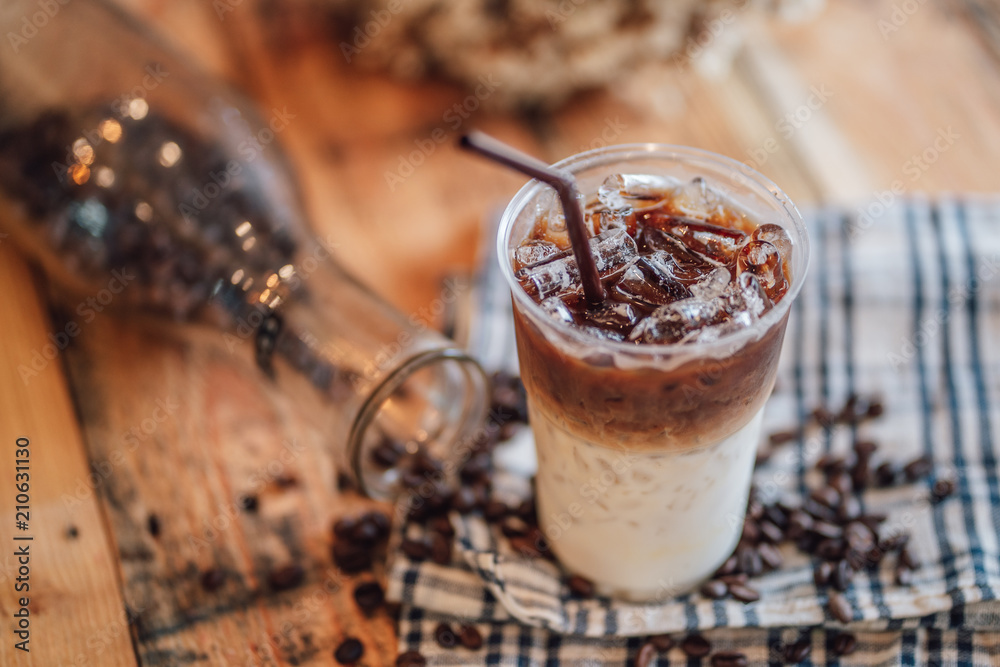 caramel macchiato ice In plastic glass, coffee ice on wood caramel macchiato ice In plastic glass, coffee ice on wood