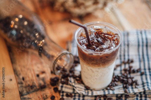 caramel macchiato ice In plastic glass, coffee ice on wood