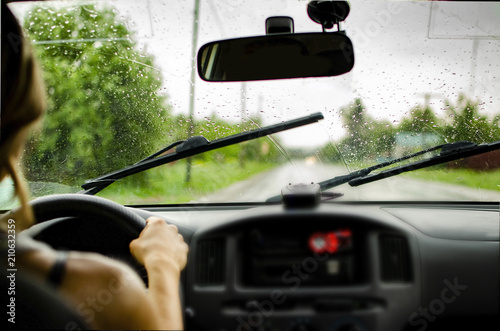 girl driving a car rides along the road