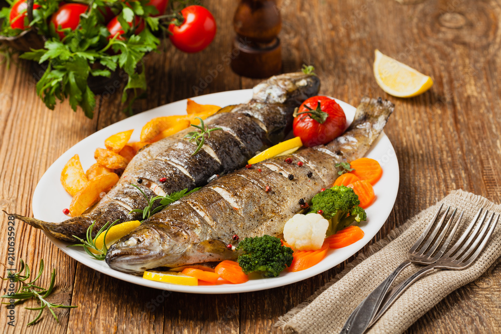 Grilled whole trout. Served with baked potatoes. Grilled whole trout. Served with baked potatoes.