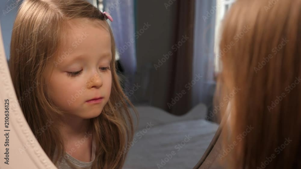 Frustrated sad little kid girl blurred vision problem for the first time puts on glasses before going to school Frustrated sad little kid girl blurred vision problem for the first time puts on glasses before going to school