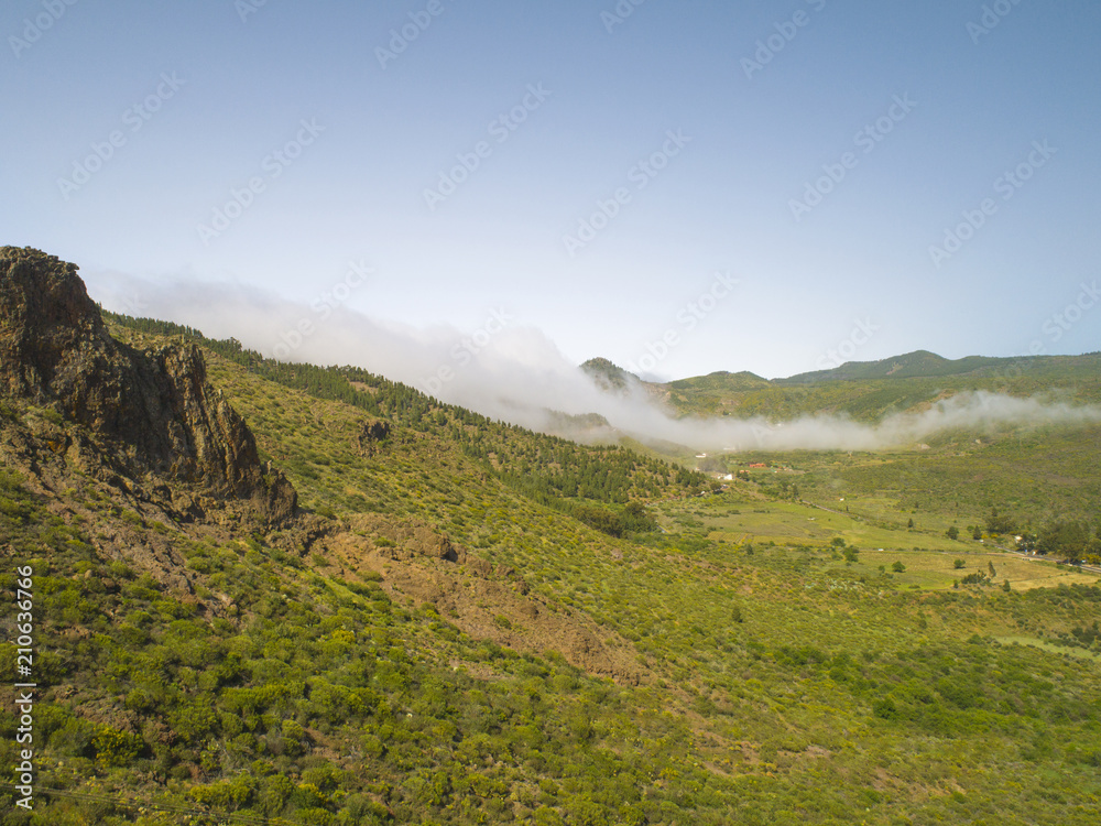 Stunning landscape mountain view. Small village in the fog. Deep canyon on a paradise island. Beautiful golden hour sunrise sunset soft light. Travel photo, postcard. Masca, Tenerife, Canary Islands