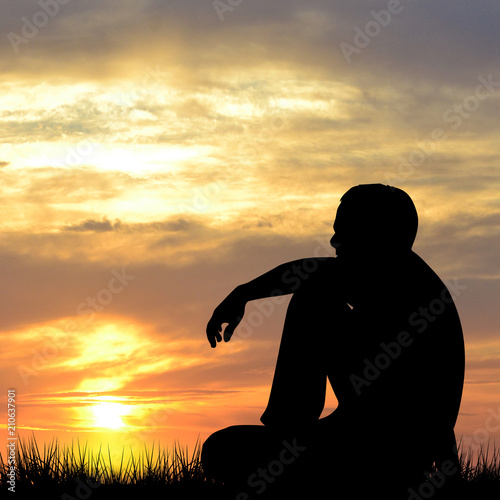 Silhouette of man watching the sunrise