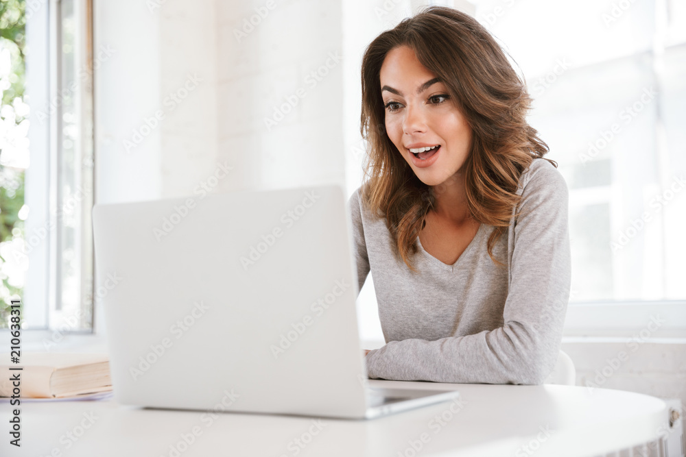 Surprised emotional young lady sitting in classroom Surprised emotional young lady sitting in classroom