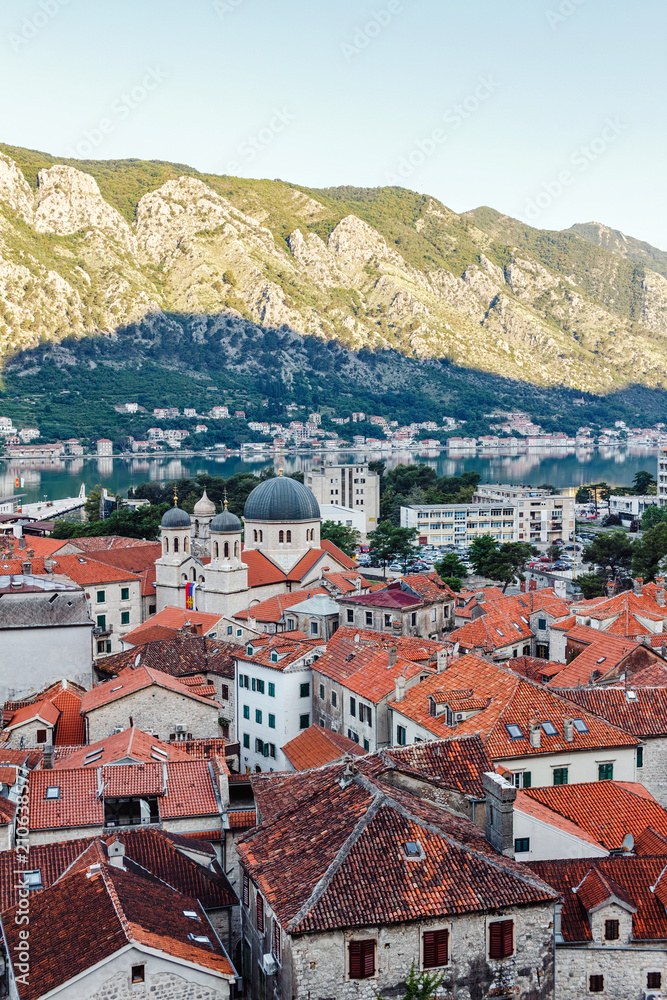 View from above on old historical city Kotor, with orange tiling roofs, morning time, Montenegro