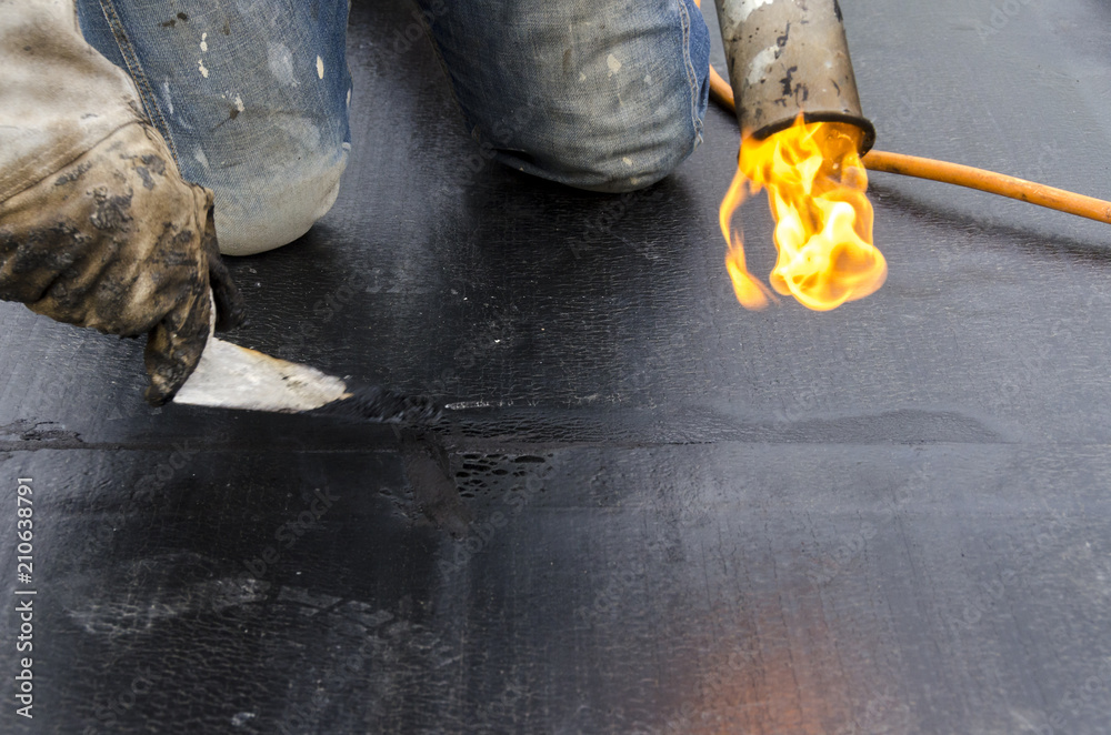 laying of waterproofing sheathing and insulation during the renovation of a roof in Italy Stock