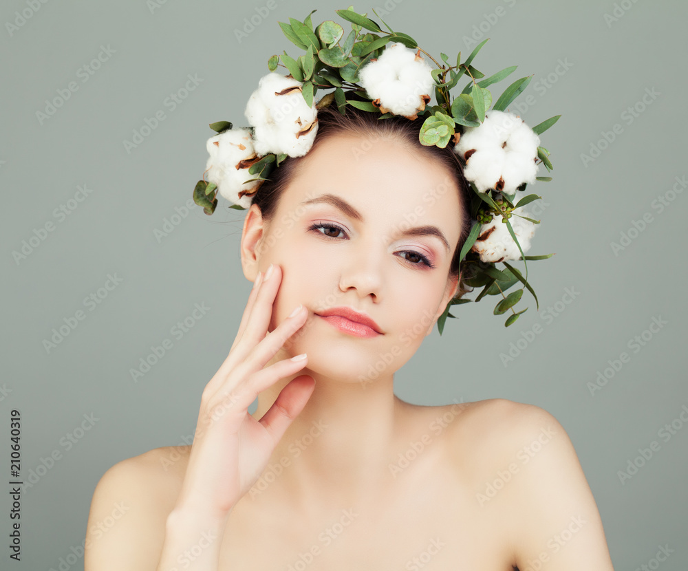 Cute Model Woman with Healthy Skin and White Cotton Flowers. Skincare and Cosmetology Concept Cute Model Woman with Healthy Skin and White Cotton Flowers. Skincare and Cosmetology Concept