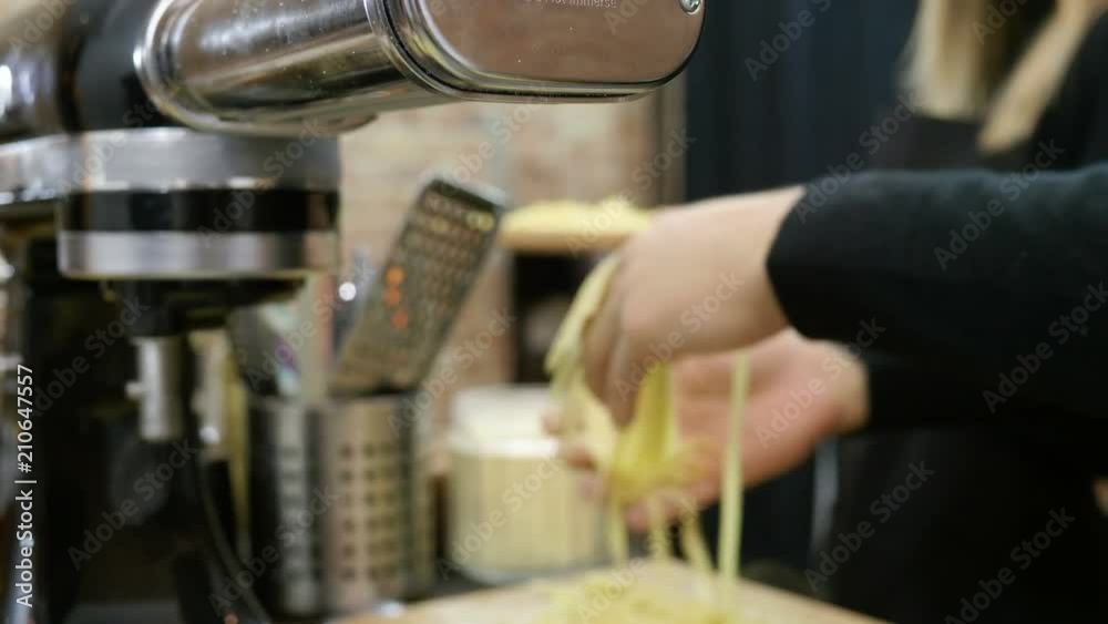 Group of people making pasta from dough using pasta machine at cooking master class. 4K Group of people making pasta from dough using pasta machine at cooking master class. 4K