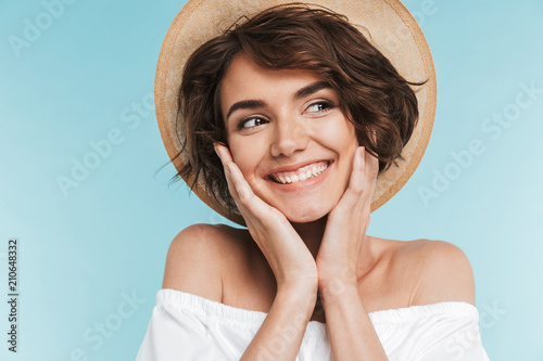 Close up of a smiling young woman in summer hat