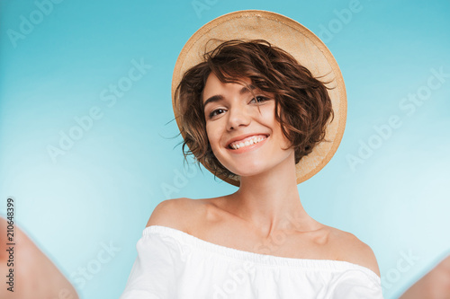 Portrait of a smiling young woman taking a selfie