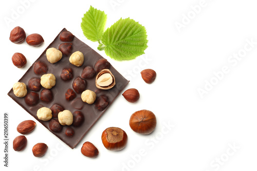 chocolate with hazelnuts and leaves isolated on white background. top view