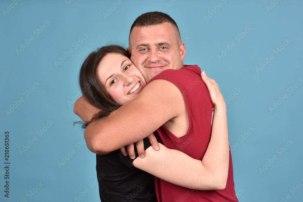 Young family on a blue background. Perfect pair. A good relationship. Strong friendship. Young family on a blue background. Perfect pair. A good relationship. Strong friendship.