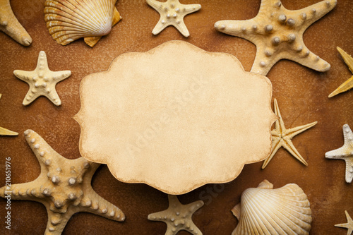 Paper card and seashells on homemade paper sheet background