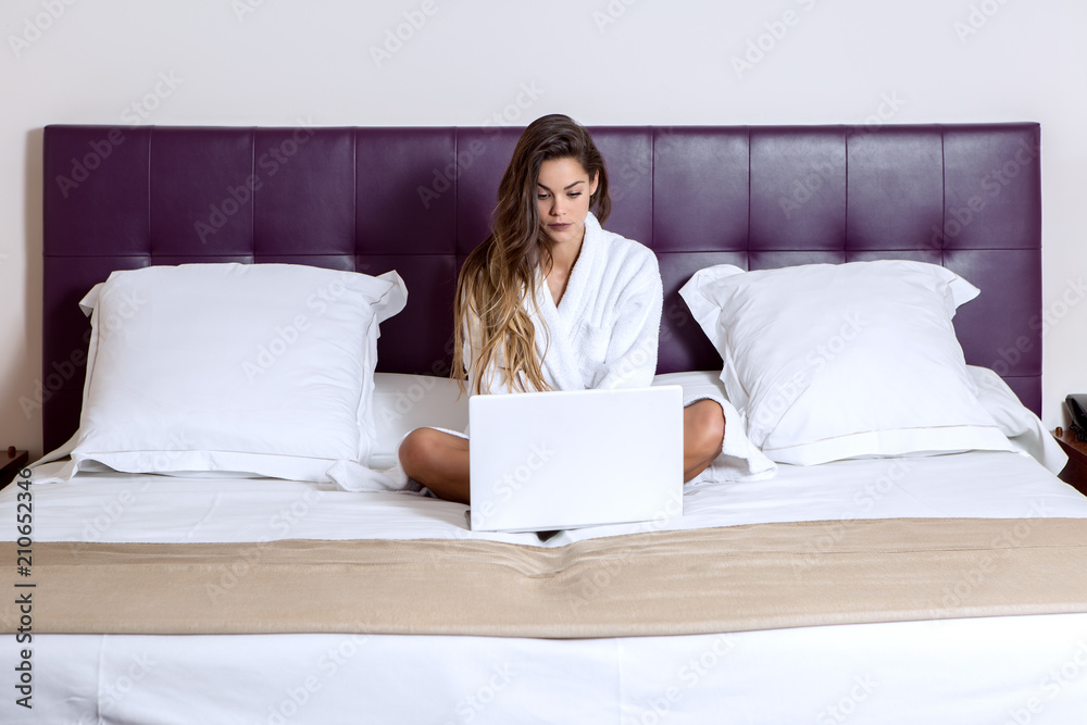 Woman working on laptop in hotel Woman working on laptop in hotel