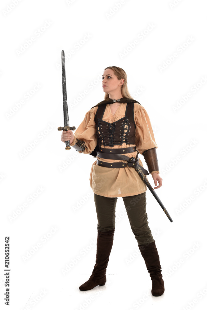 full length portrait of girl wearing brown medieval costume,. standing pose, isolated on white studio background. full length portrait of girl wearing brown medieval costume,. standing pose, isolated on white studio background.