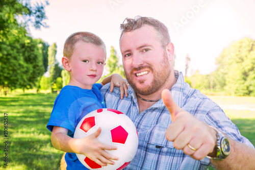 father and son playing with soccer ball © Lsantilli