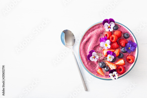 healthy summer berry smoothie bowl with flowers and chia seed