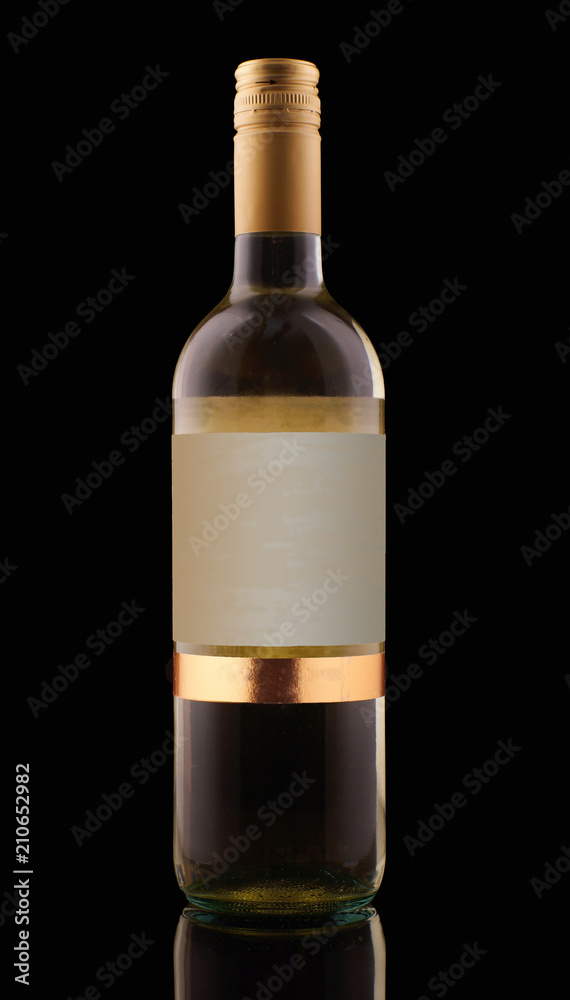 A bottle of white wine on a dark background with a blank label A bottle of white wine on a dark background with a blank label
