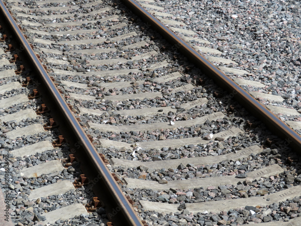 Naklejka premium Railway rails with concrete sleepers and granite gravel