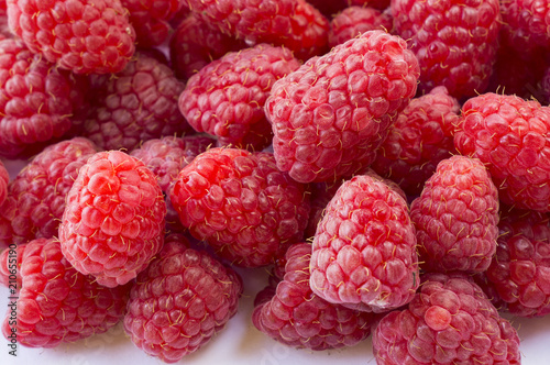 Background of raspberries. Fresh raspberries closeup. Top view. Background of red berries. Various fresh summer fruits.