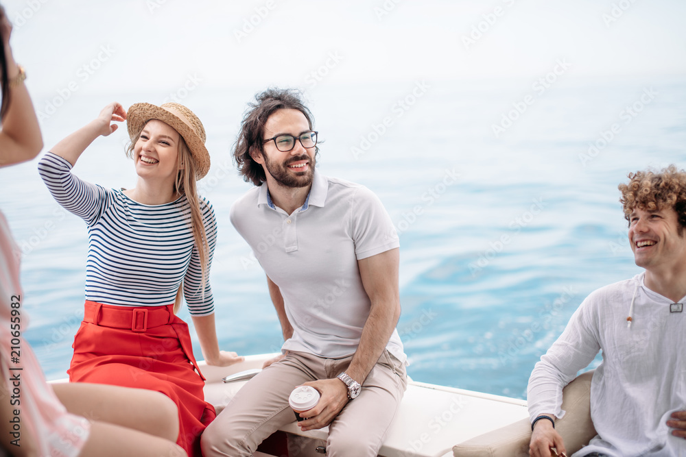 Caucasian attractive just married couple having their honeymoon trip on a luxury sailing boat at summer Carribean Sea