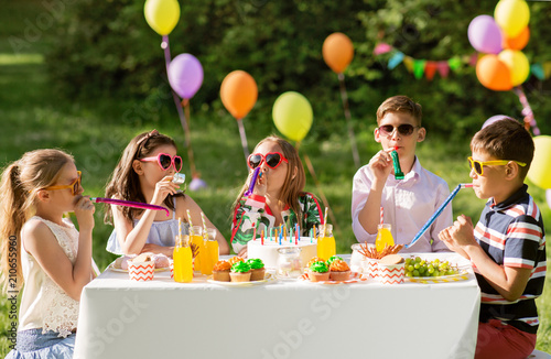 Canvas Print holidays, childhood and celebration concept - happy kids with cake blowing party