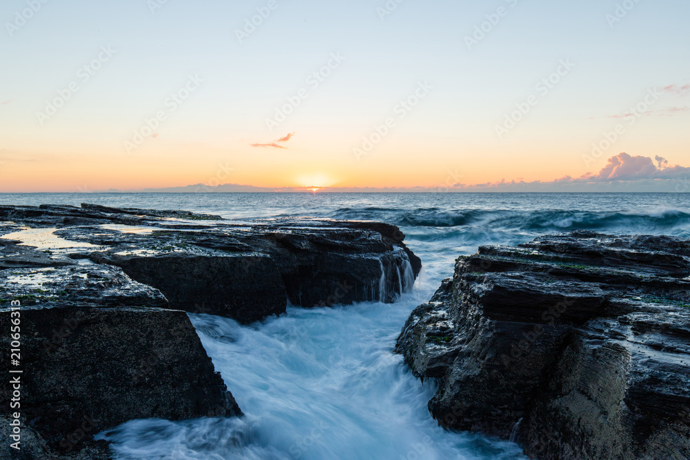 Wave water flowing through between rocks. Wave water flowing through between rocks.